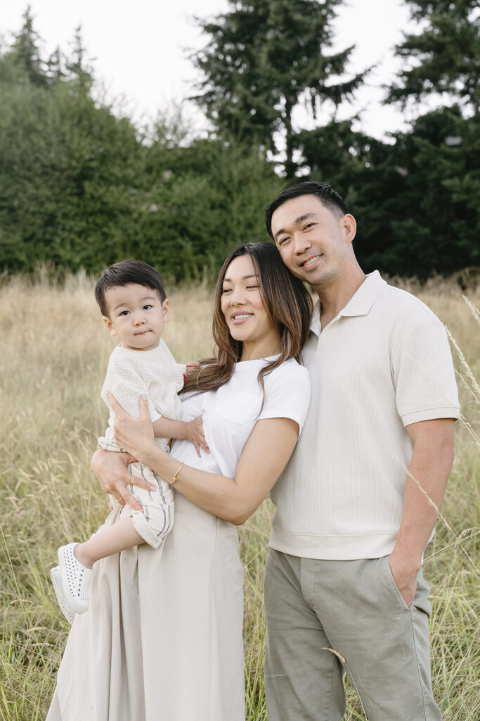 family taking photos in a field
