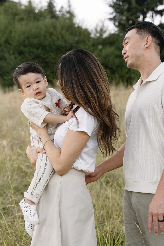 family taking photos in a field
