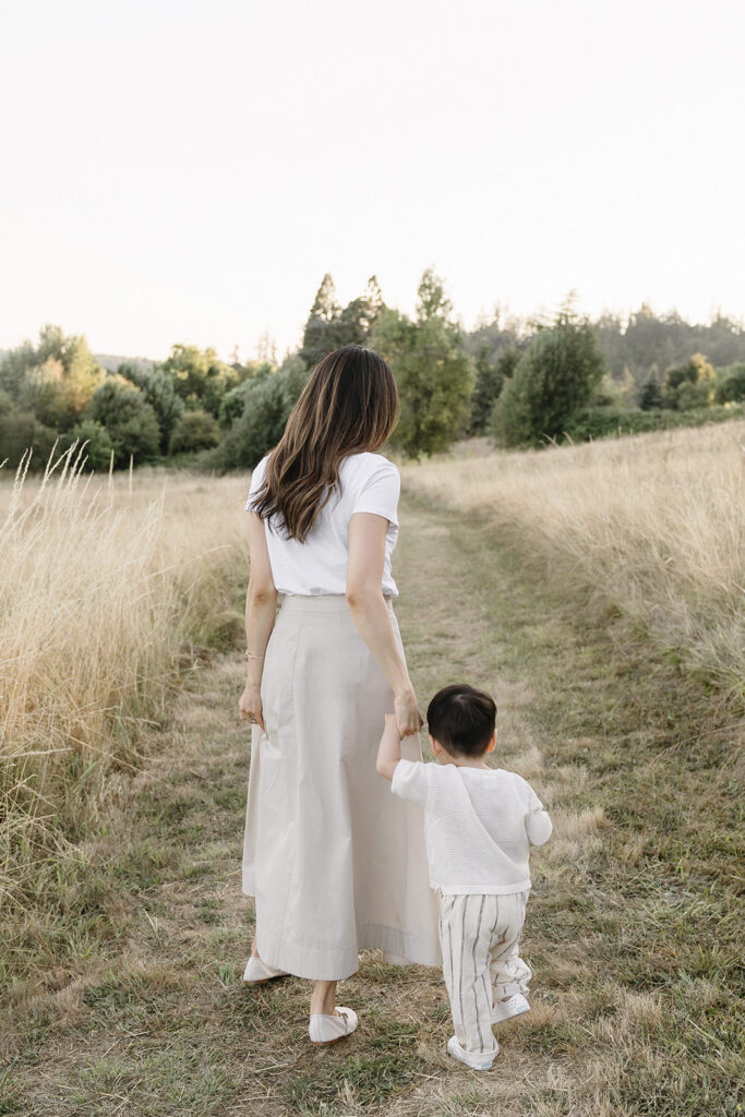 family taking photos in a field
