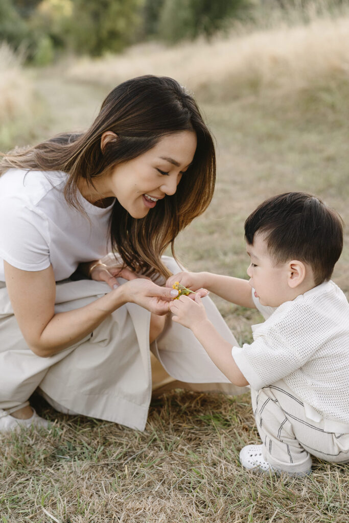 family taking photos in a field
