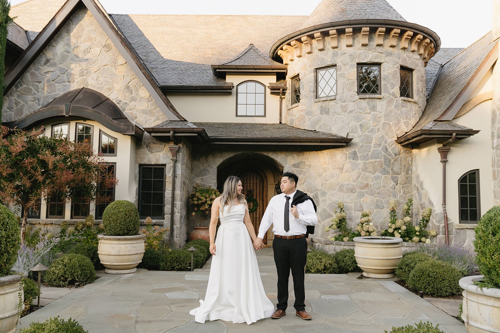 A couple embracing during their European-inspired pre-wedding portraits at Chateau De Leon in Portland.