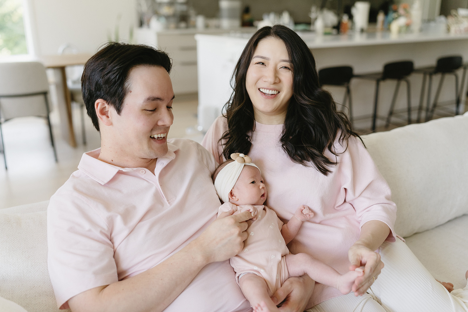 A family snuggled up at home during their newborn photoshoot in Camas, Washington.