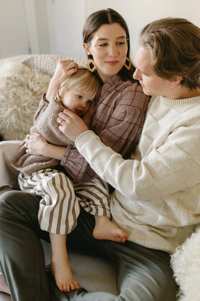 A loving family of three spending time together in their Portland home during an in-home session.
