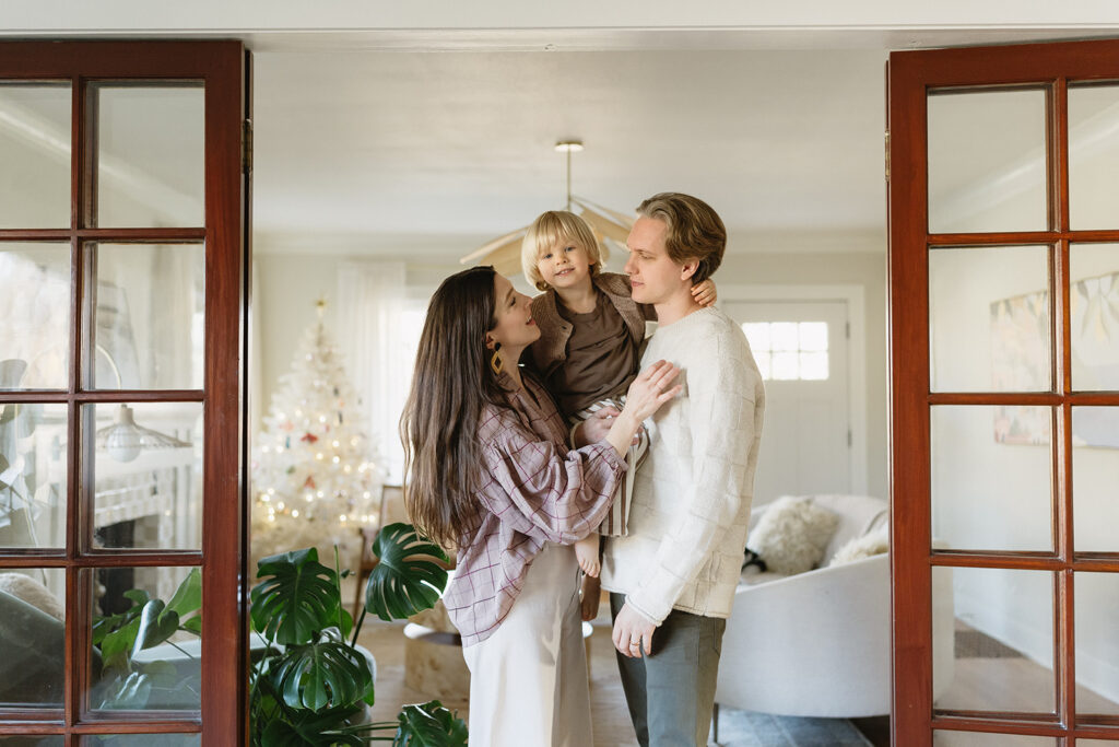 A loving family of three spending time together in their Portland home during an in-home session.
