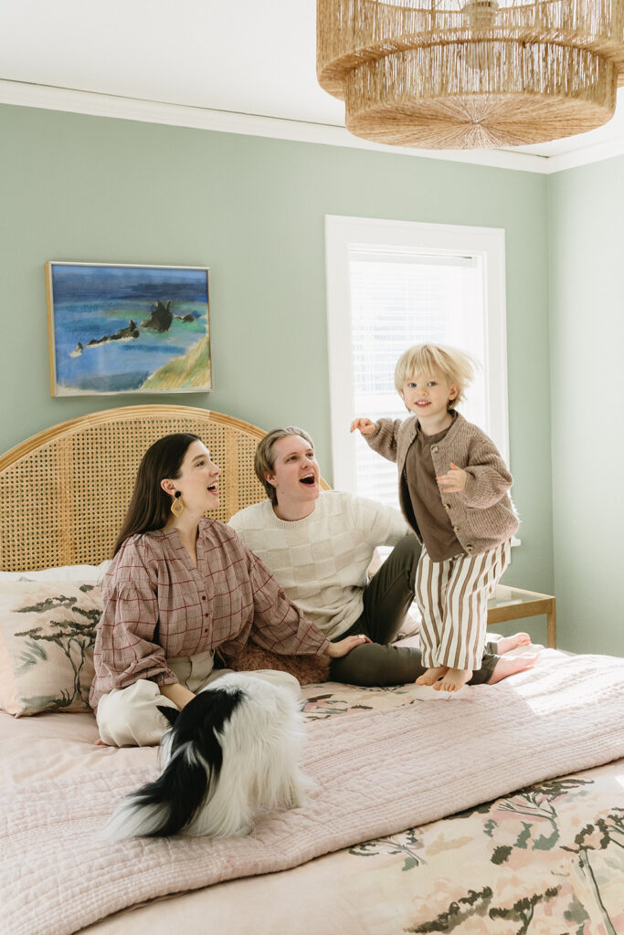 A family of three enjoying a candid moment during their in-home photo session in Portland.
