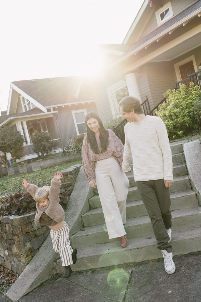 A family of three enjoying a candid moment during their in-home photo session in Portland.
