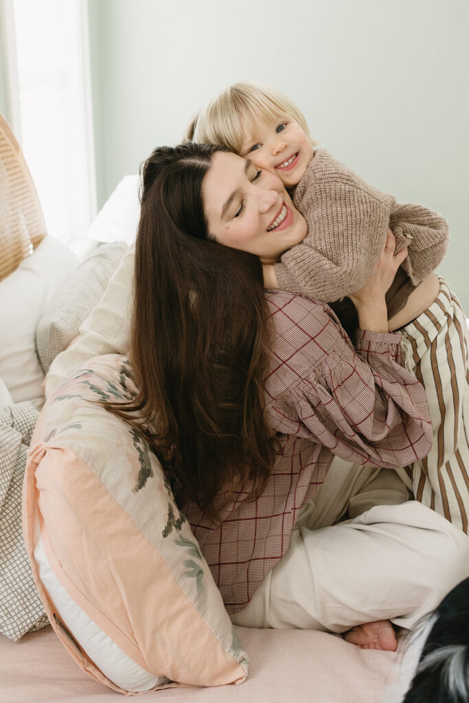 A family of three enjoying a candid moment during their in-home photo session in Portland.
