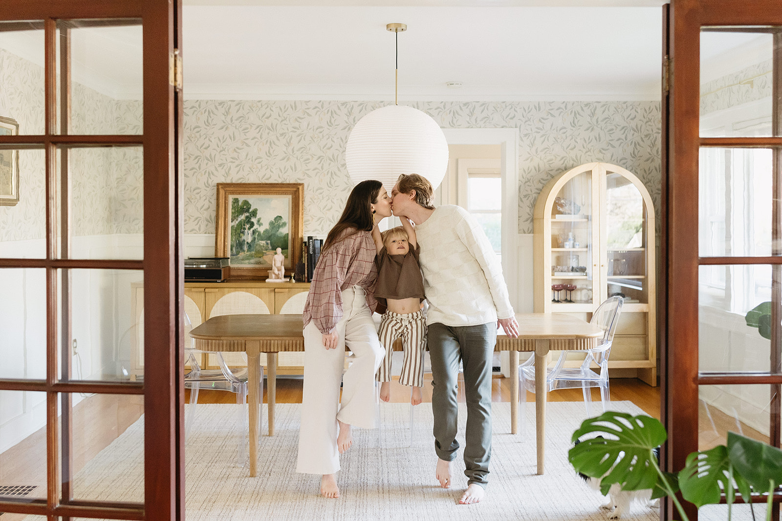 A family of three enjoying a candid moment during their in-home photo session in Portland.