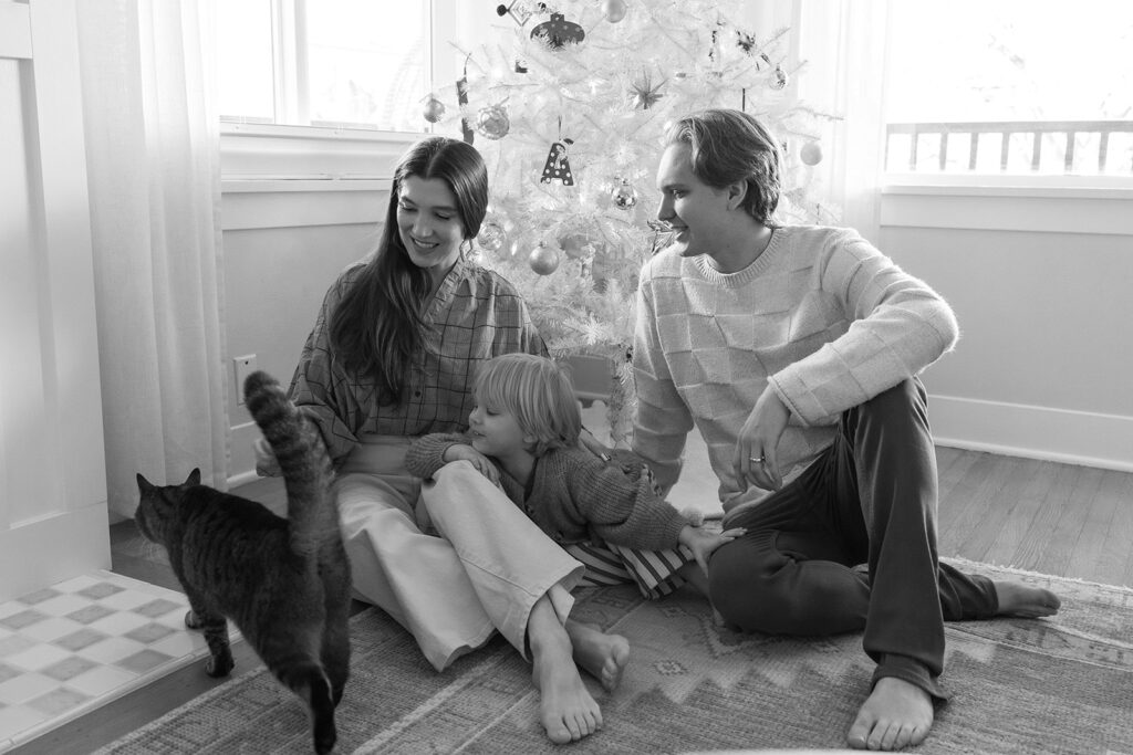 A family of three enjoying a candid moment during their in-home photo session in Portland.
