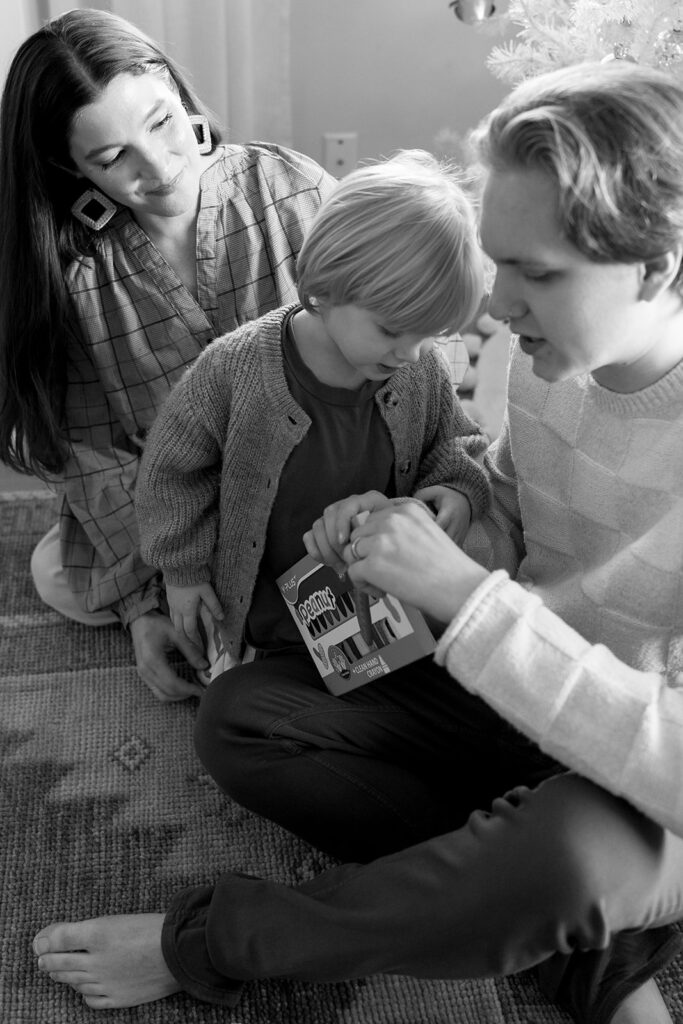 A family of three enjoying a candid moment during their in-home photo session in Portland.
