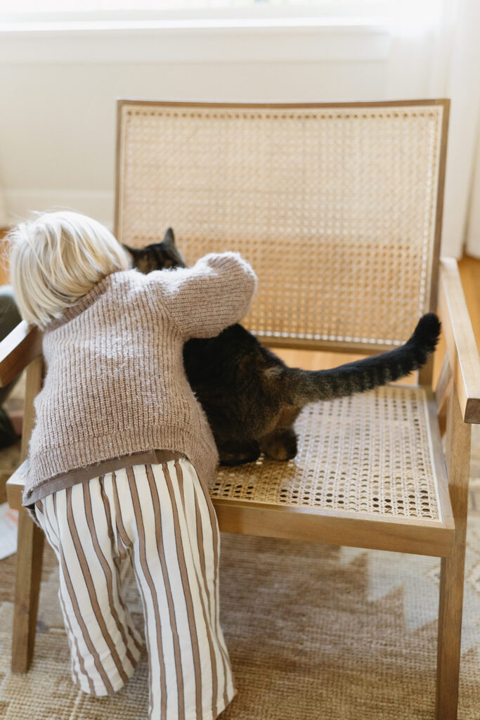 A family of three enjoying a candid moment during their in-home photo session in Portland.
