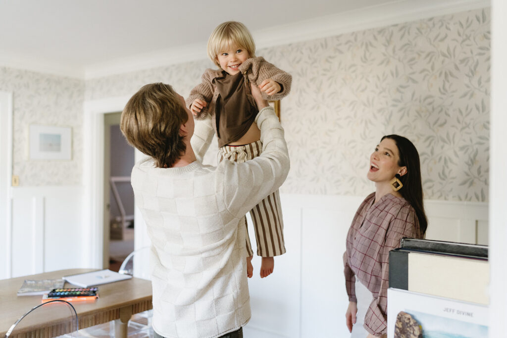 Candid photos of a family of three in their Portland home, surrounded by everyday moments.
