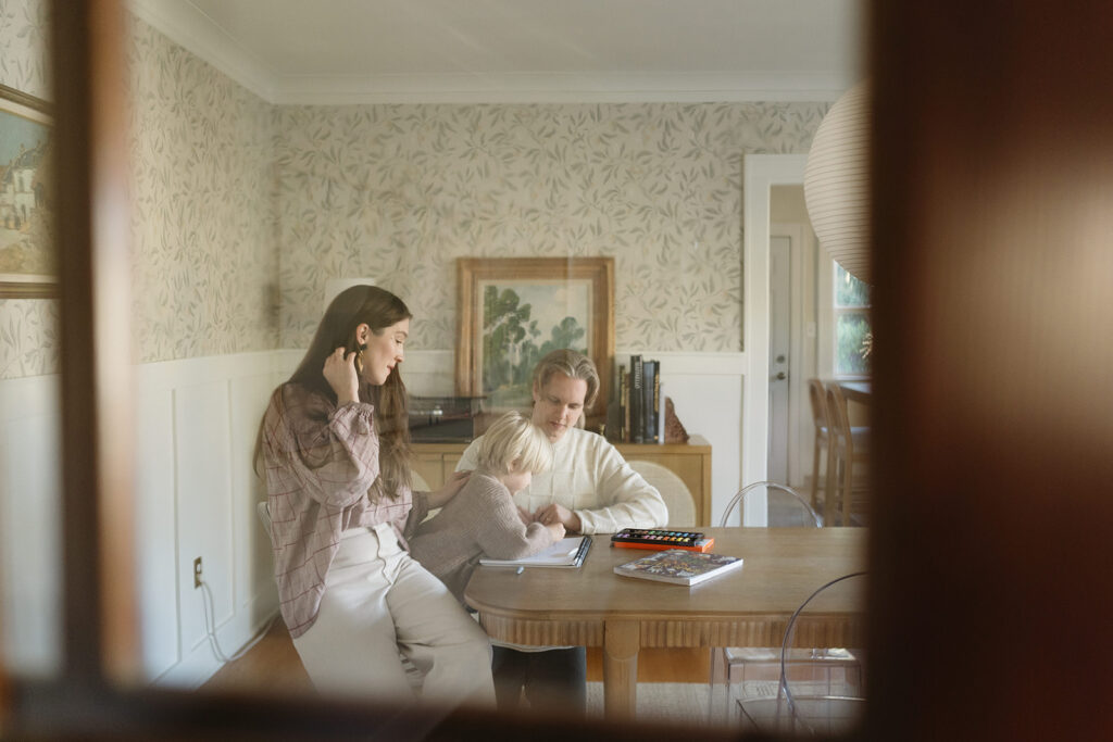 A loving family of three spending time together in their Portland home during an in-home session.
