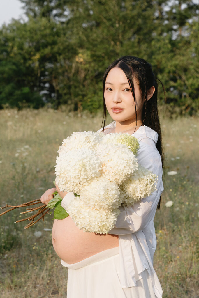 a couple posing for their maternity photos in oregon
