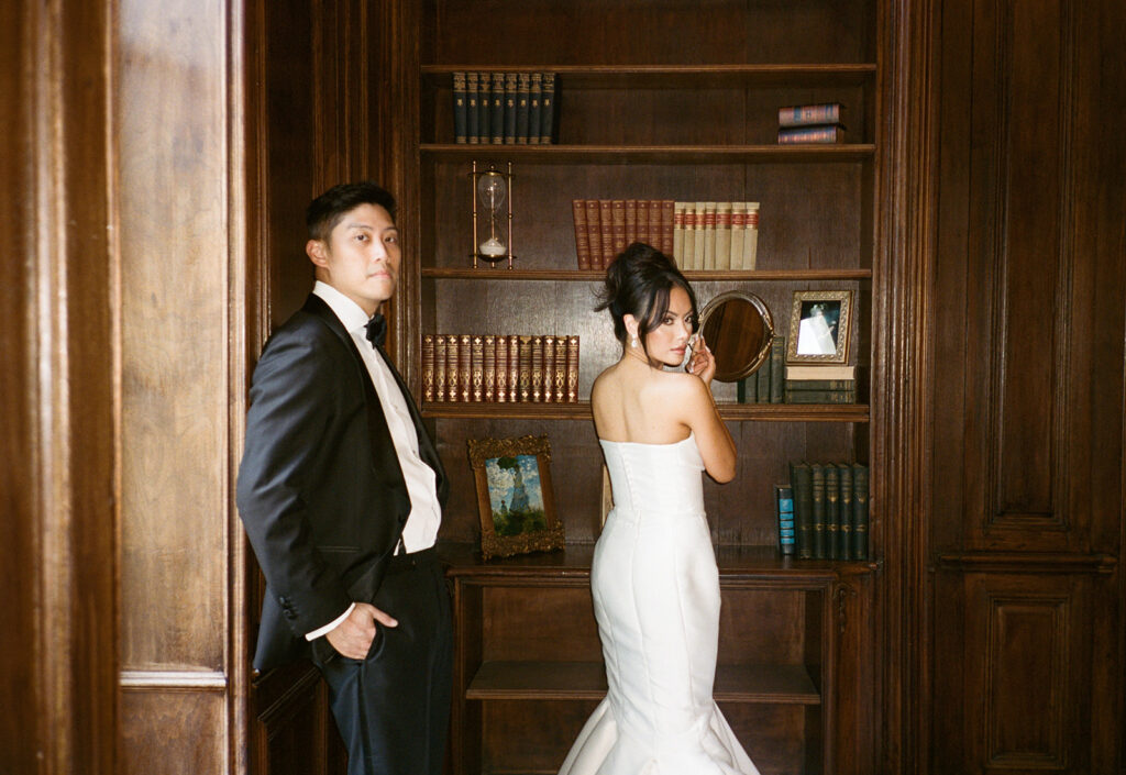 Bride and groom pose in front of The Chauteau Nouvelle in Houston, Texas, surrounded by elegant architecture before their wedding.
