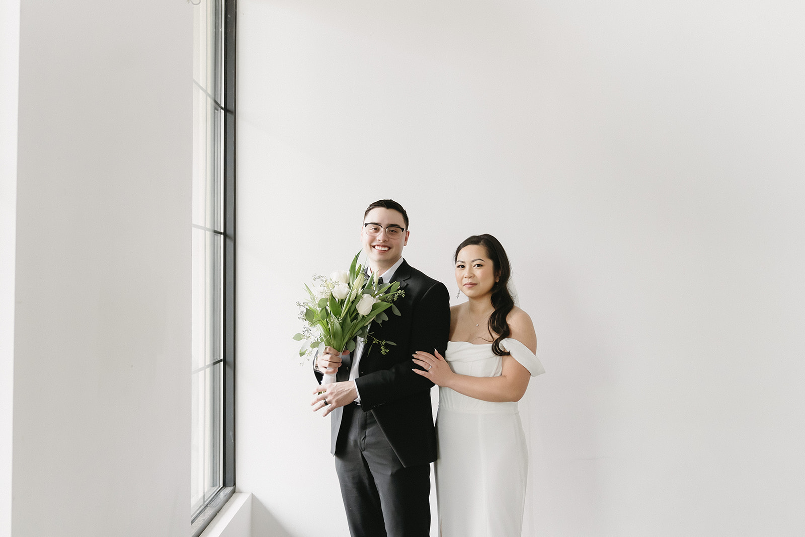 A couple posing in a studio in Washington for elegant and classic pre-wedding photos.