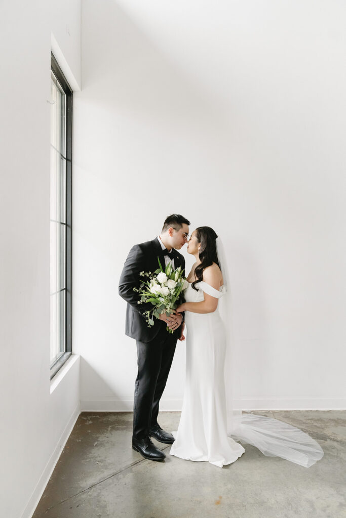 A bride and groom-to-be posing for simple and classic engagement photos in a Washington studio.
