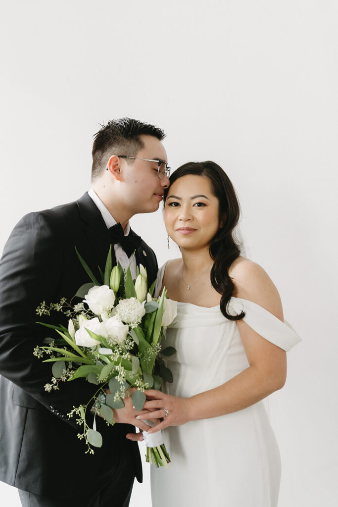 A bride and groom-to-be posing for simple and classic engagement photos in a Washington studio.
