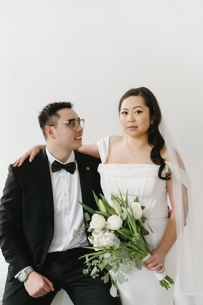 A couple posing in a studio in Washington for elegant and classic pre-wedding photos.
