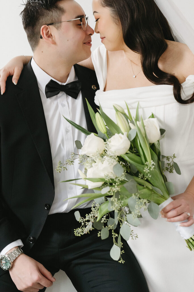 A couple posing in a studio in Washington for elegant and classic pre-wedding photos.
