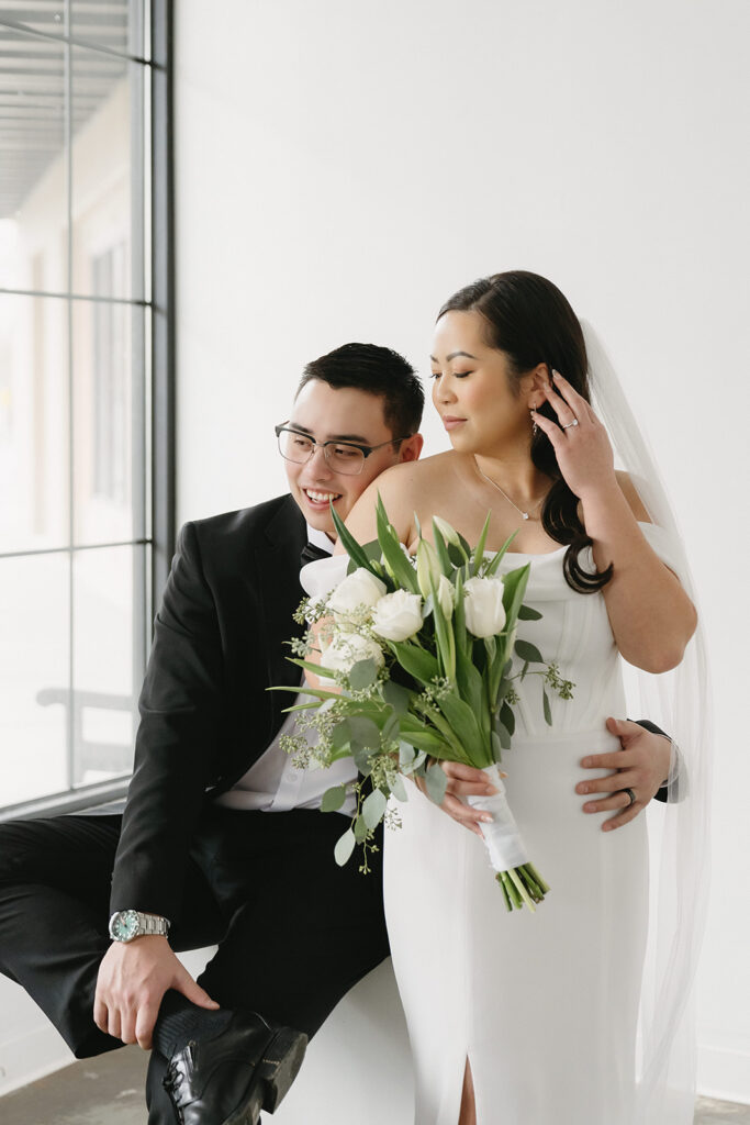 A couple posing in a studio in Washington for elegant and classic pre-wedding photos.
