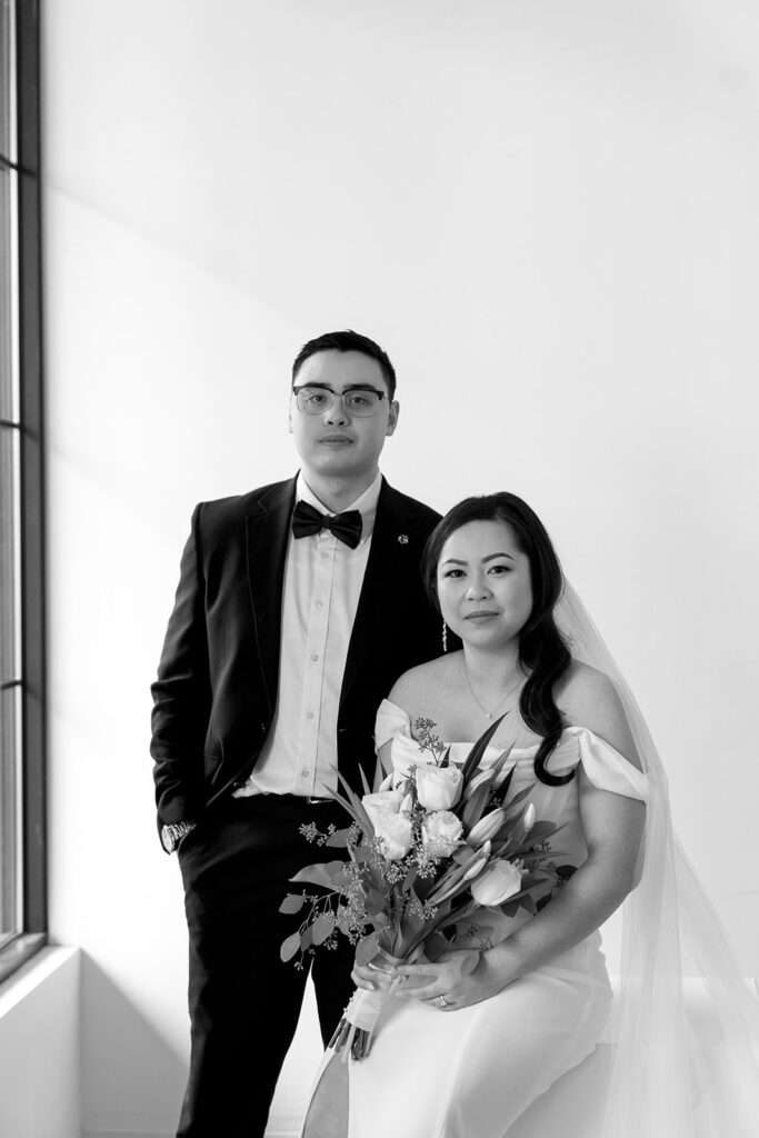 A couple posing in a studio in Washington for elegant and classic pre-wedding photos.
