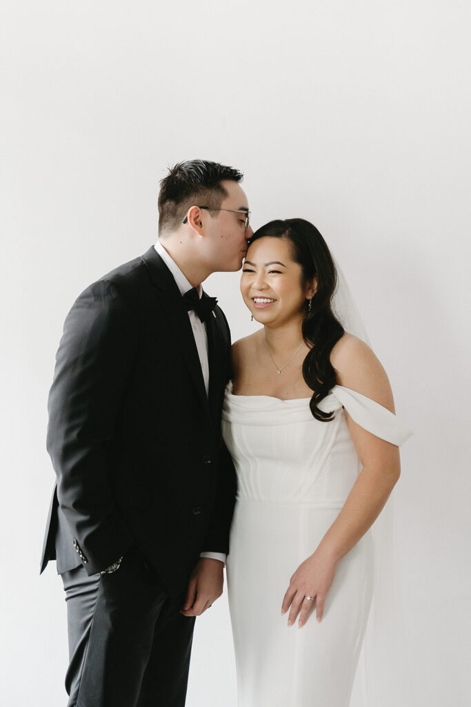 A bride and groom-to-be posing for simple and classic engagement photos in a Washington studio.
