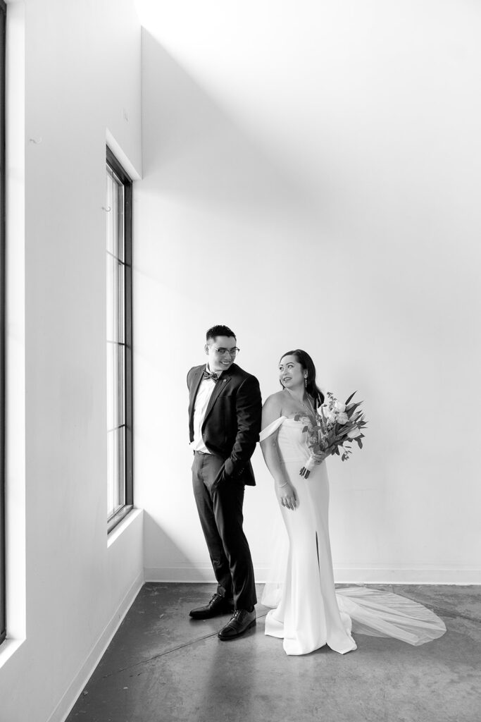 A bride and groom-to-be posing for simple and classic engagement photos in a Washington studio.
