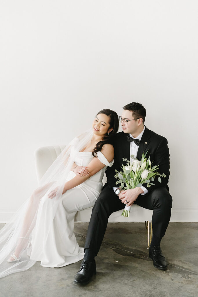 A bride and groom-to-be posing for simple and classic engagement photos in a Washington studio.
