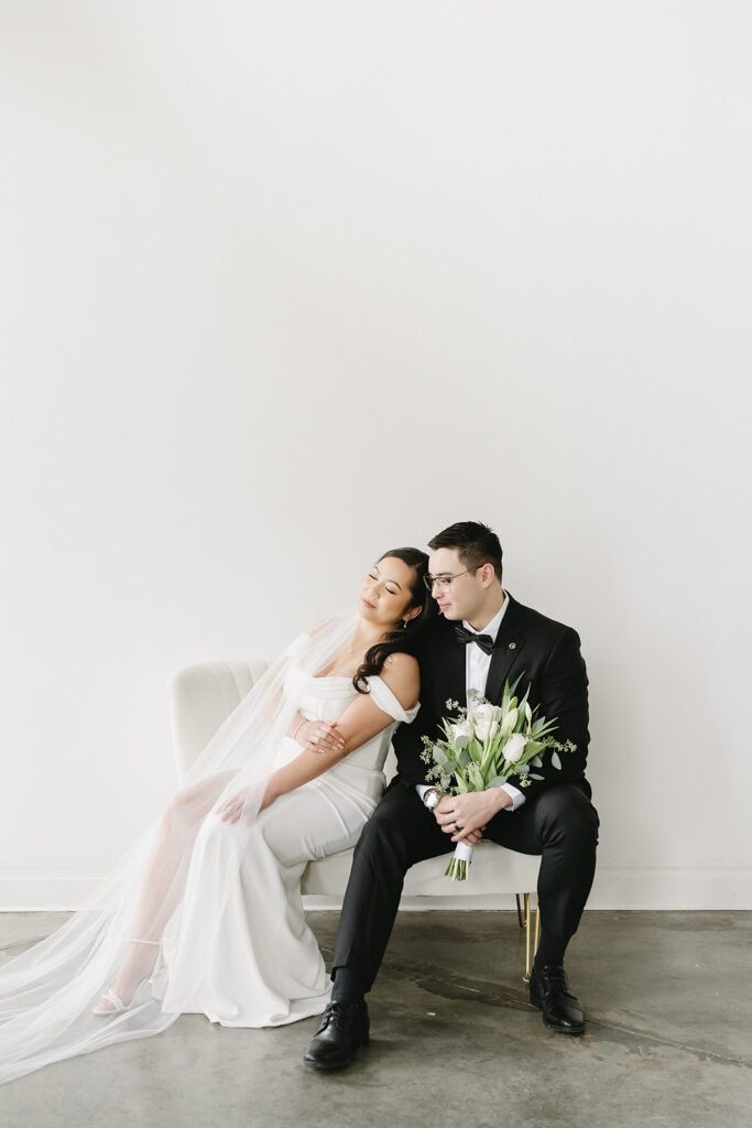 A bride and groom-to-be posing for simple and classic engagement photos in a Washington studio.
