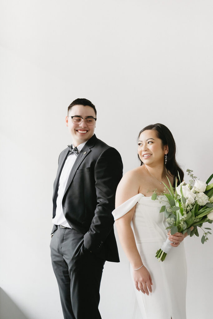 A bride and groom-to-be posing for simple and classic engagement photos in a Washington studio.
