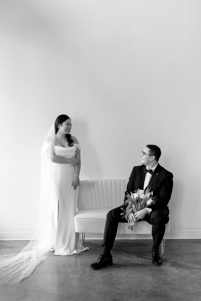 A bride and groom-to-be posing for simple and classic engagement photos in a Washington studio.
