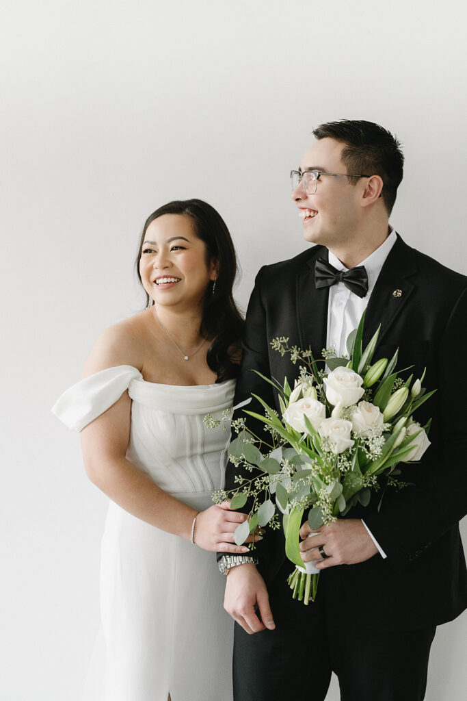 A bride and groom-to-be posing for simple and classic engagement photos in a Washington studio.
