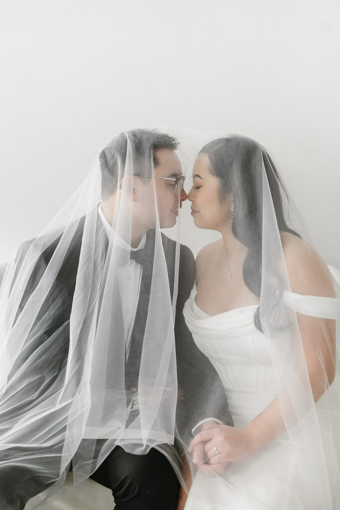 A couple posing in a studio in Washington for elegant and classic pre-wedding photos.
