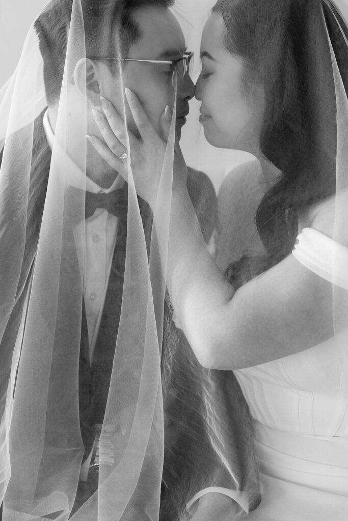 A bride and groom-to-be posing for simple and classic engagement photos in a Washington studio.
