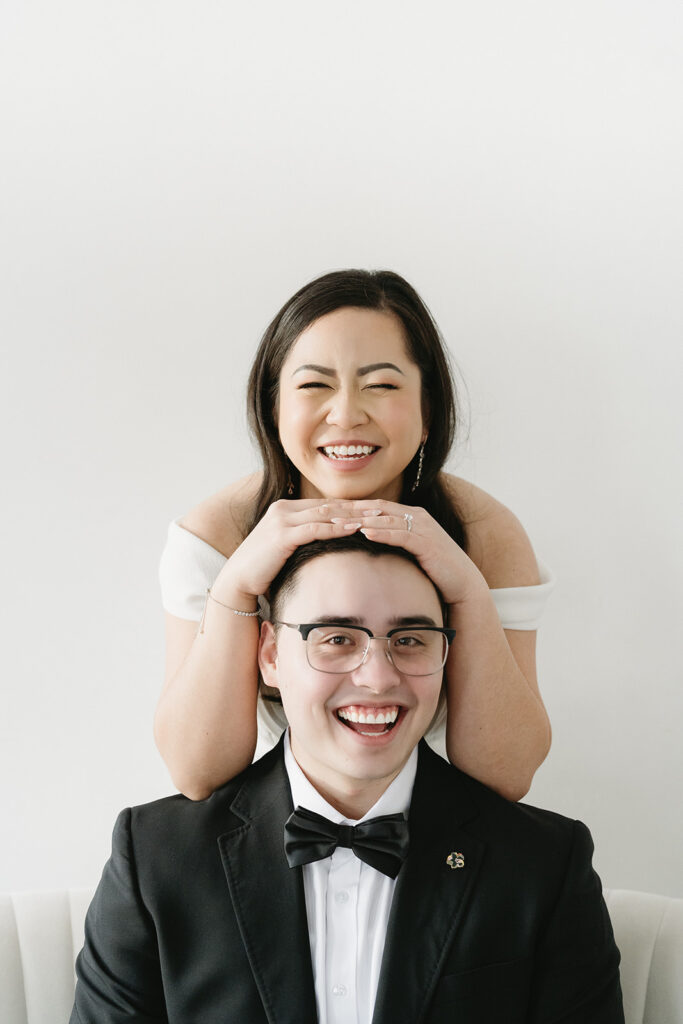 A bride and groom-to-be posing for simple and classic engagement photos in a Washington studio.
