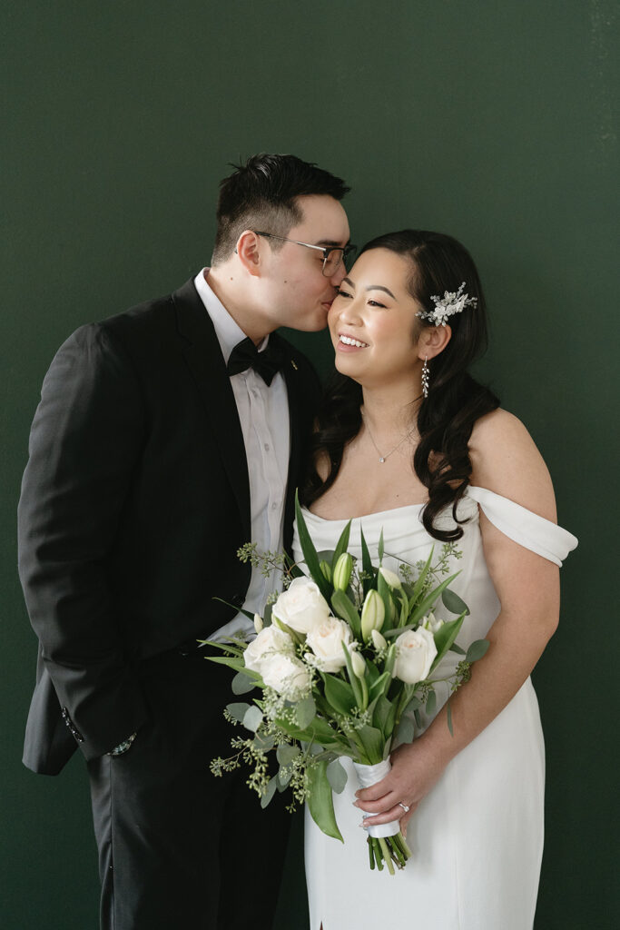 A bride and groom-to-be posing for simple and classic engagement photos in a Washington studio.
