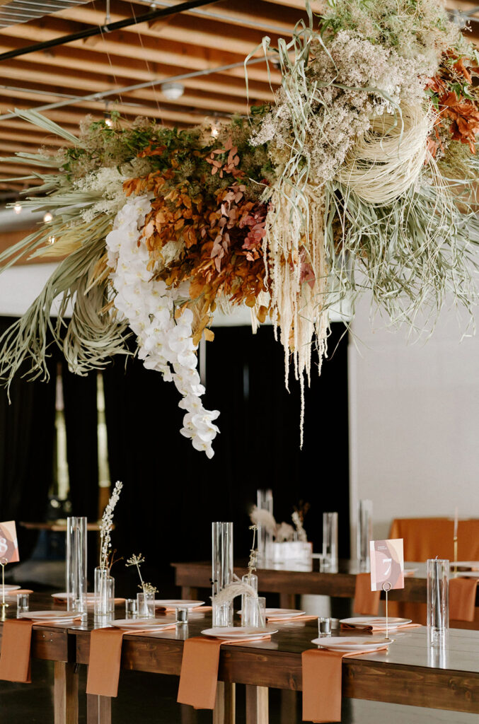 floral installation above dinner tables 