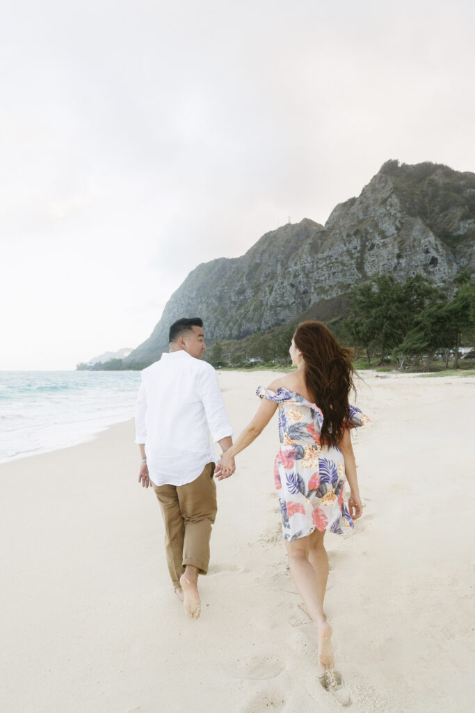 a couple posing for romantic beach photos - a Proposal in Hawaii
