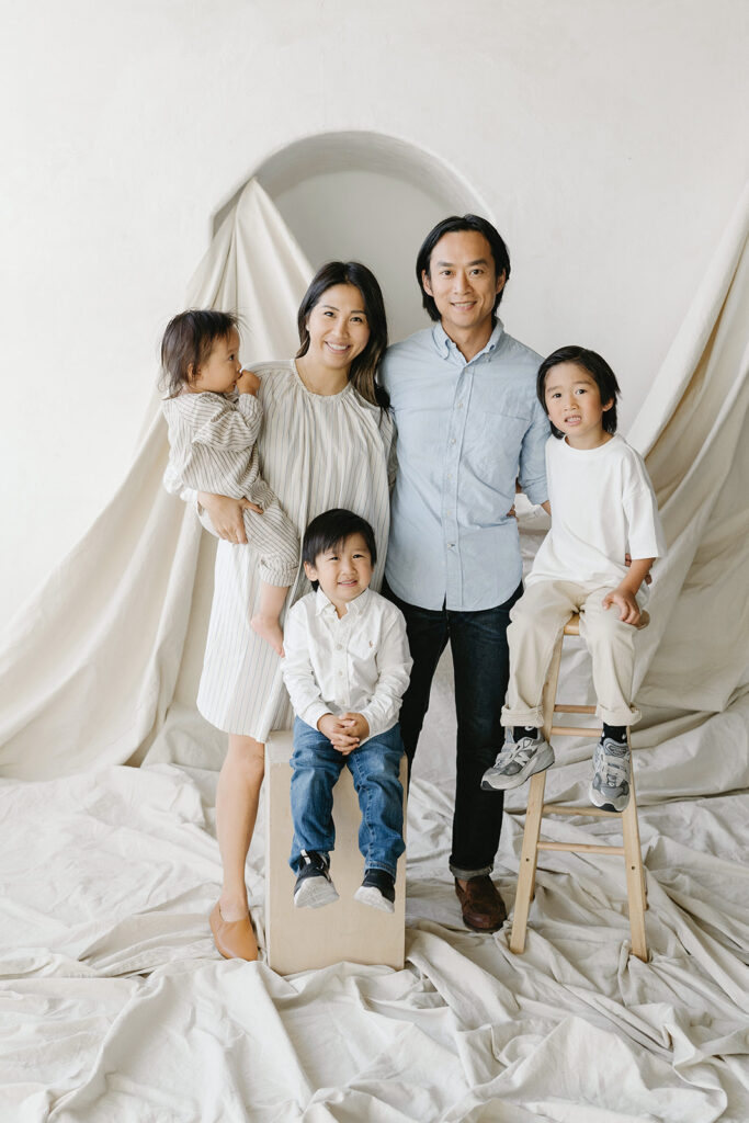Family posing together in a studio photoshoot.

