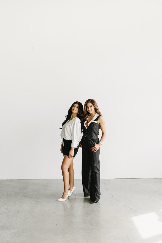 Mother and daughter posing together during a fun and fashionable photoshoot in a studio
