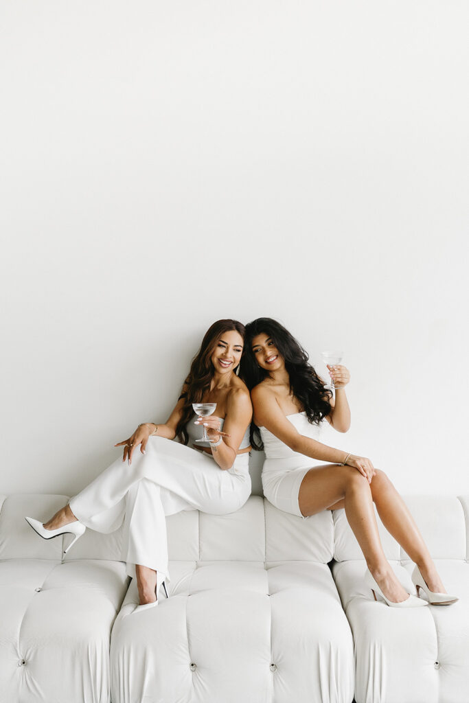 Mother and daughter posing together during a fun and fashionable photoshoot in a studio
