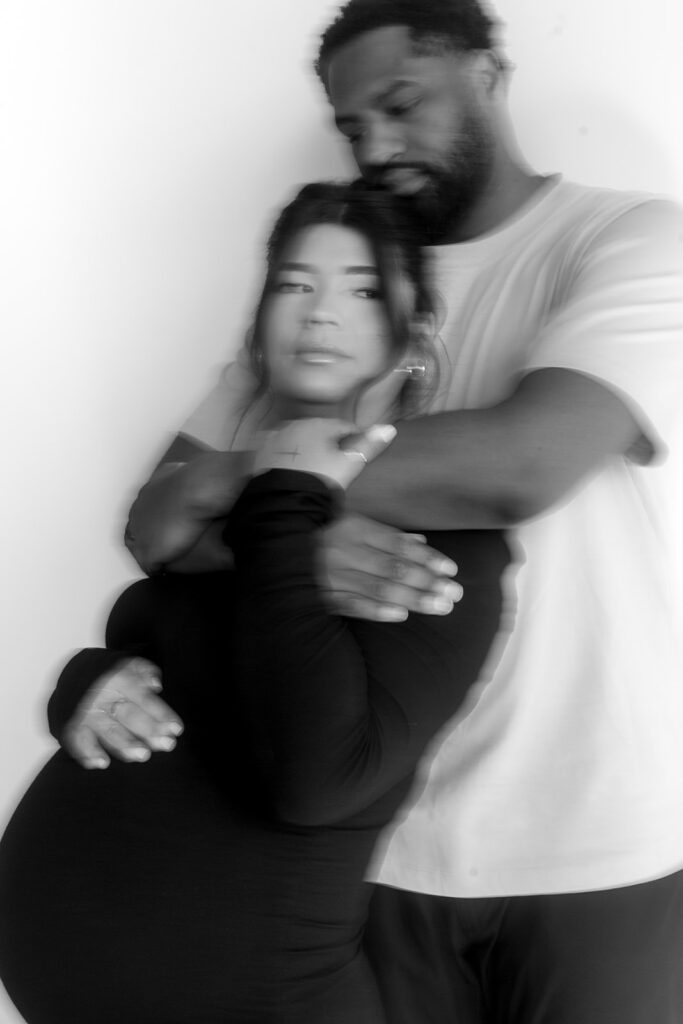 Couple posing together during an intimate maternity session
