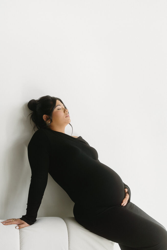 Minimalist maternity portrait with floral accents in natural light-aesthetic maternity shoot
