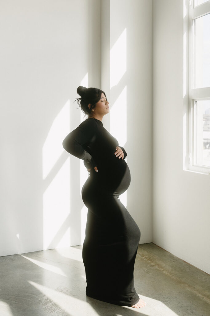 Studio maternity photo of expecting mother with soft draping and neutral tones-aesthetic maternity shoot
