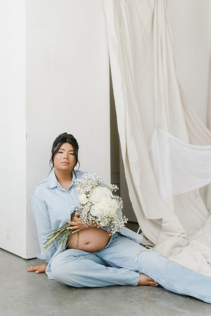 Studio maternity photo of expecting mother with soft draping and neutral tones-aesthetic maternity shoot