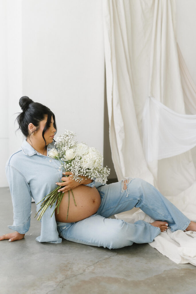 Minimalist maternity portrait with floral accents in natural light-aesthetic maternity shoot
