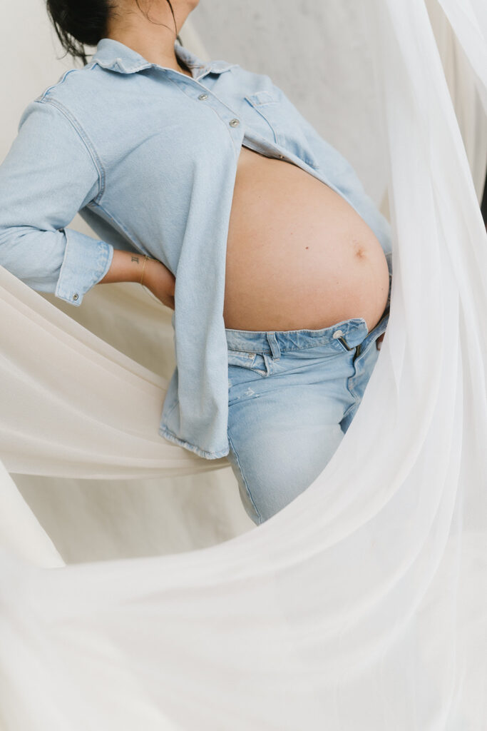 Minimalist maternity portrait with floral accents in natural light
-aesthetic maternity shoot