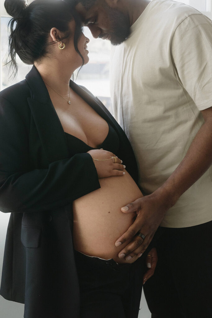 Minimalist maternity portrait with floral accents in natural light-aesthetic maternity shoot
