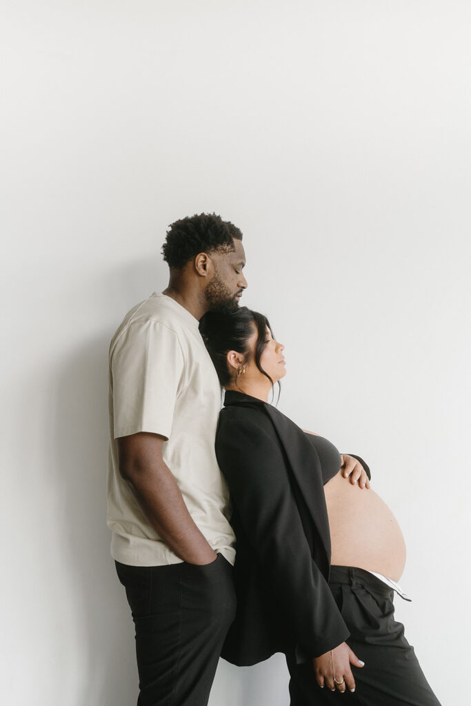 Minimalist maternity portrait with floral accents in natural light-aesthetic maternity shoot
